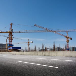construction-site-with-cranes-against-blue-sky